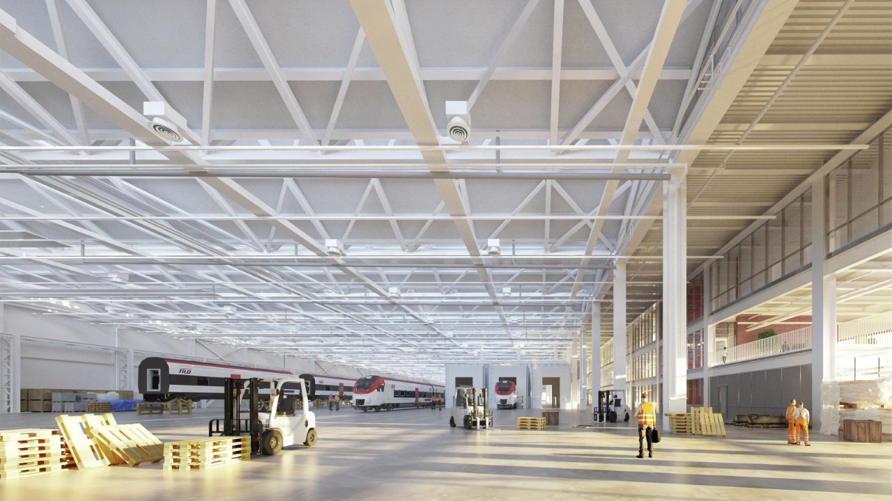 Visualizzazione dell’interno dell’edificio capannone con i binari lunghi e ampi spazi luminosi, grazie alle ampie finestre e ai lucernari.